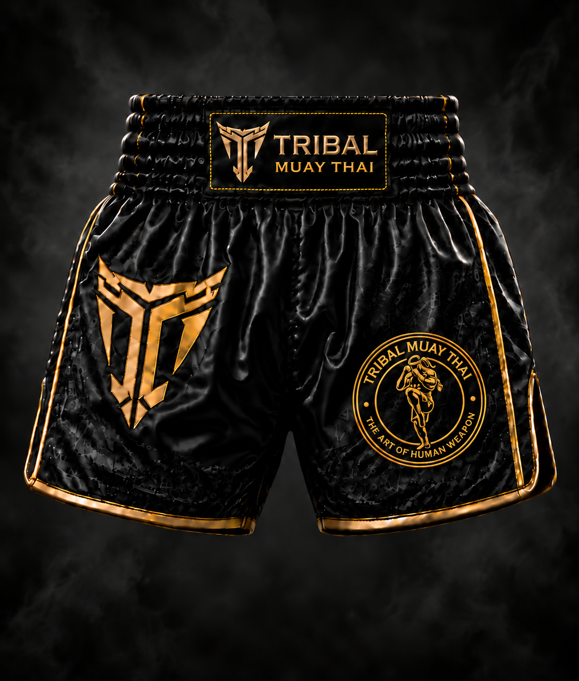 Black satin Tribal Muay Thai shorts with gold piping and branding